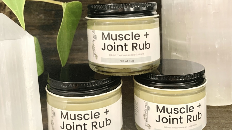 A group of three jars filled with natural muscle and joint rub .